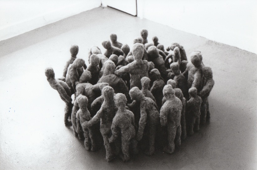 A group of felt figures stand in a circle