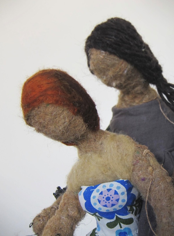 Two dolls head's together