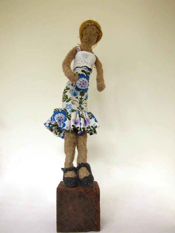 Doll in a blue and white tropical dress