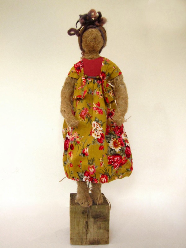 Doll in a yellow and red floral dress