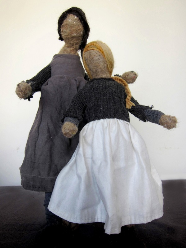 Two dolls in black, white and grey dresses